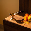 Brass Diya with Wooden Handle styled on a pooja altar